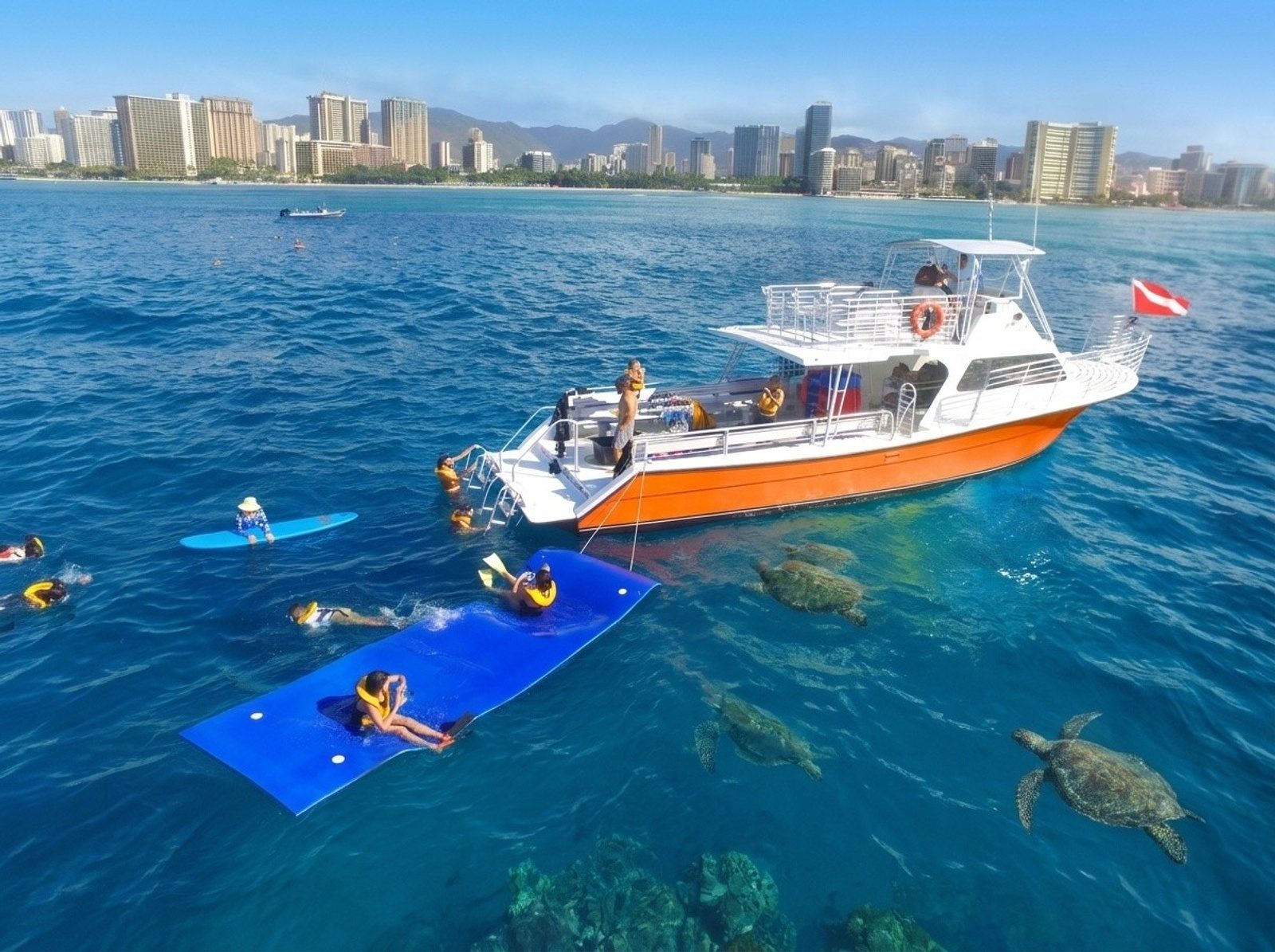 The snorkel boat anchored off Waikiki with guests on a floating mat and a turtle surfacing nearby